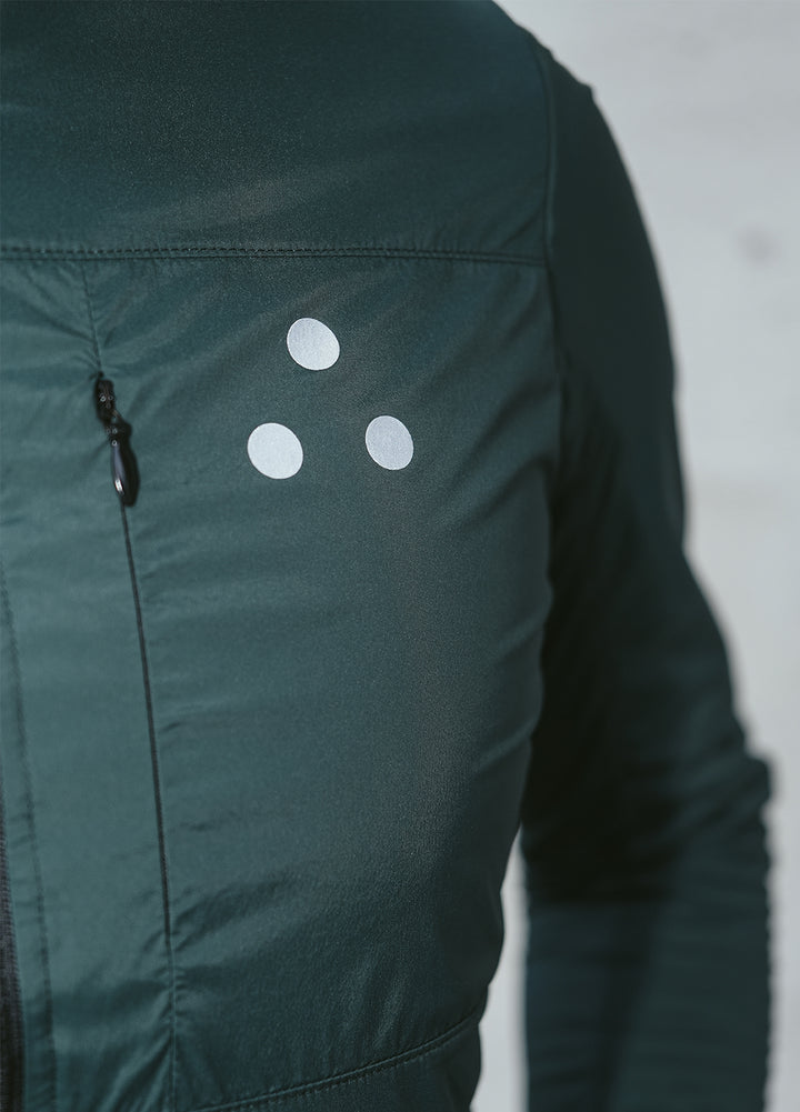 Green DRS cycling jacket with white circular patterns on a neutral background